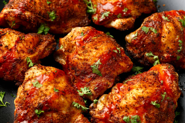 istock Chicken Thighs topped with buffalo sauce. 2168456213