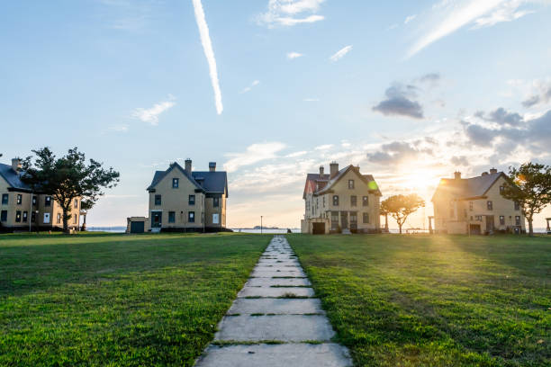 Person walking towards a sustainable off the grid house at sunset