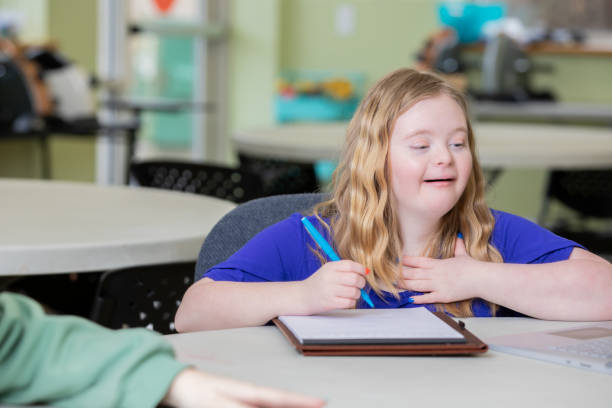 istock A female teen high school student works on her homework with a classmate. 2168458053