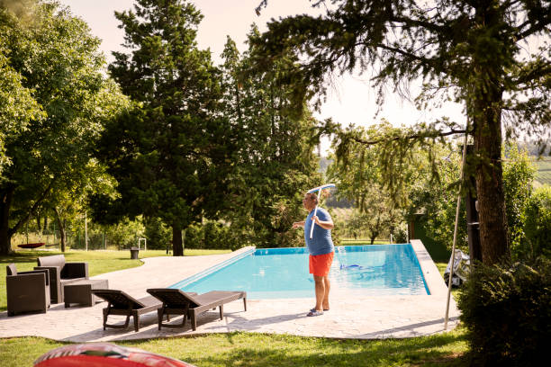 istock Pool guy cleaning the garden with pool 2168458336