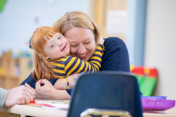 istock A mother lovingly embraces her young daughter with Down Syndrome. 2168461455