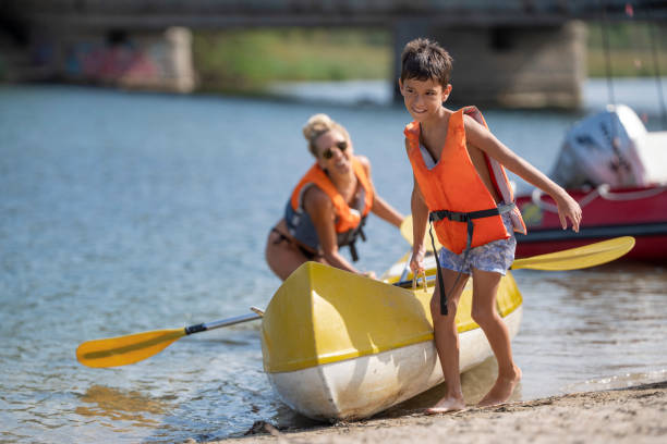 istock Boy with his mother kayaking on the river in their summer vacation 2168462777