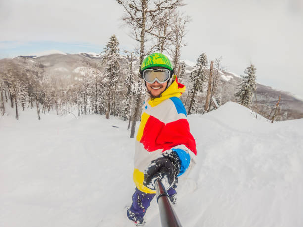 Young girl skiing and having fun with snowcovered mountinrange in the background in the ski resort of St .Anton am Arlberg, Austria