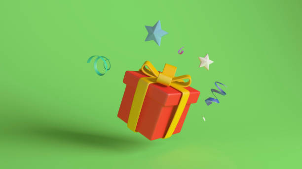 istock Red Gift Box with Yellow Ribbon and Floating Decorations on Green Background 2168469216