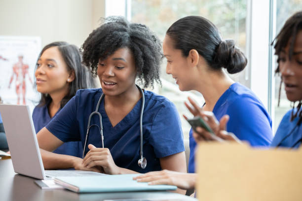 istock A class discussion includes students dressed in medical scrubs. 2168470345