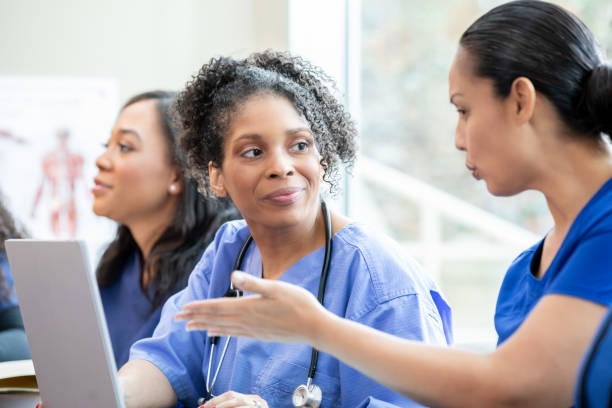 istock Within the classroom, nursing students converse and share perspectives. 2168470349