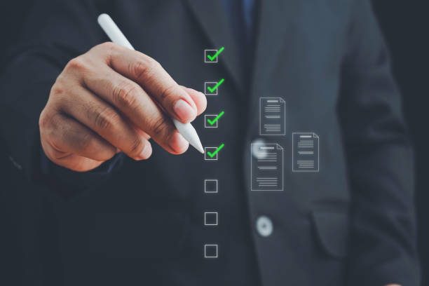 istock Businessman marks checkboxes. The survey form, check marks on a checklist, fill out online form, and answer questions. List options for business security procedures followed office. Checklist concept. 2168478269