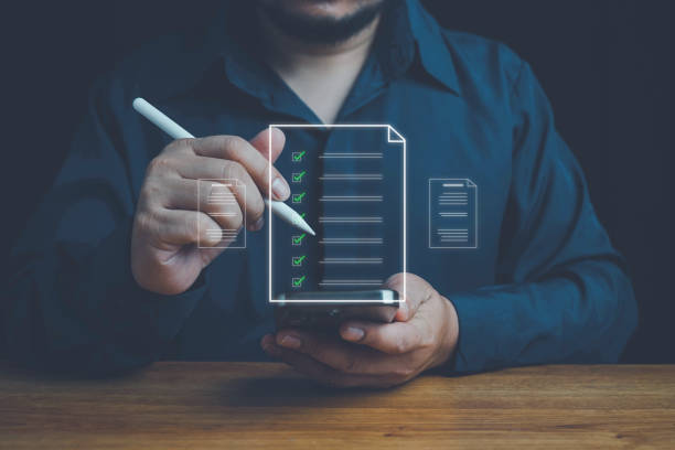 istock Businessman marks checkboxes. The survey form, check marks on a checklist, fill out online form, and answer questions. List options for business security procedures followed office. Checklist concept. 2168478272