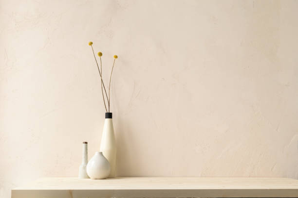 istock Stylish home interior design with dry plant and neutral textured wall copy space. Minimal product presentation background. 2168479605
