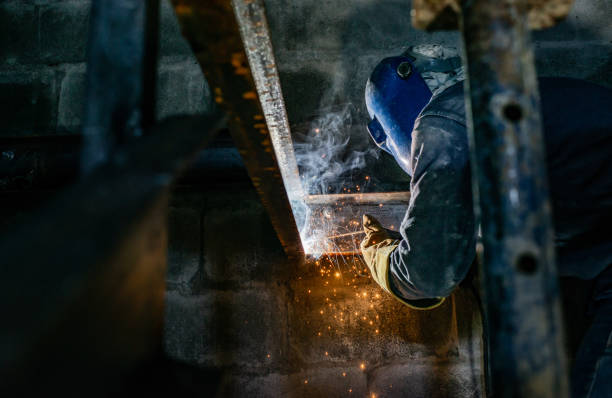 Do-it-yourself - a man does metal welding using an electric device
