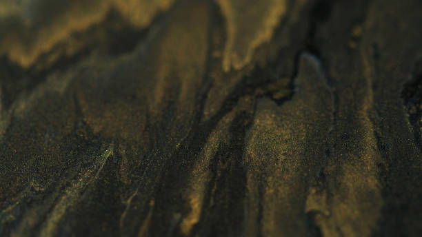 istock Glitter paint ink background gold black blend art 2168481215