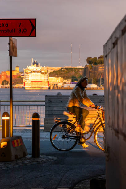 Stockholm, Sweden Aug 16, 2024 A bicylist on a bike path in thr Sussen district and the Stockholm harbor.