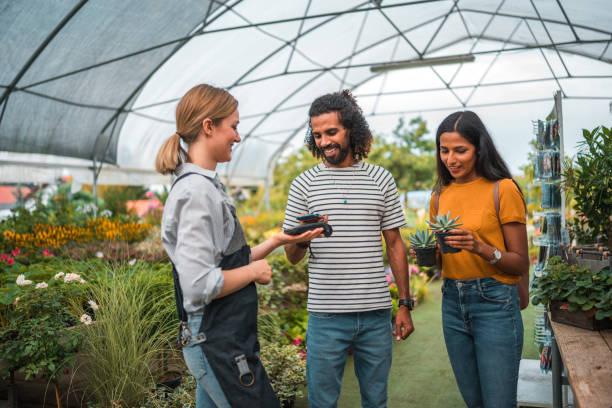 istock Diverse Couple Completes Purchase with Smartphone In Garden Center 2168482443