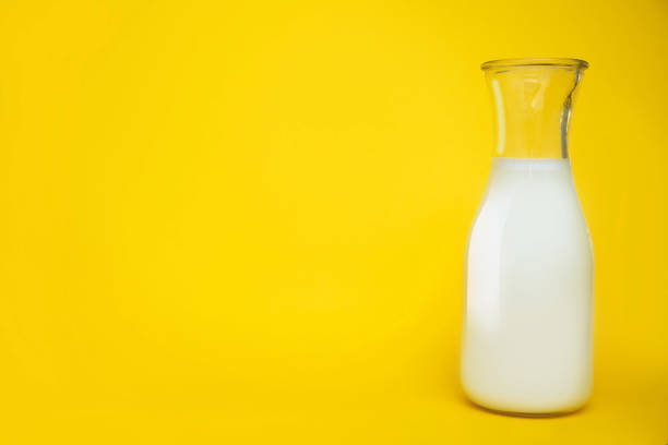 istock Milk bottle isolated on yellow background with copy space 2168483171