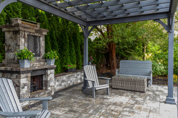 istock Large gray pergola on pavers with stone fireplace and waterfall urns for backyard oasis landscape design 2168487217