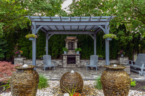 istock Large gray pergola on pavers with stone fireplace and waterfall urns for backyard oasis landscape design 2168487229