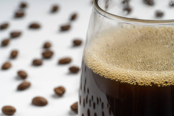 istock Glass with black coffee and beans around 2168490332