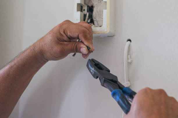 istock hands of electrician using pliers to repair a home socket 2168491831