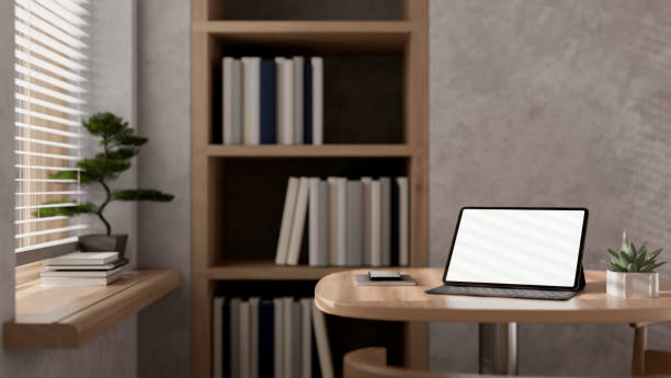 istock A digital tablet mockup and a wireless keyboard on a wooden table in a modern loft office. 2168491842