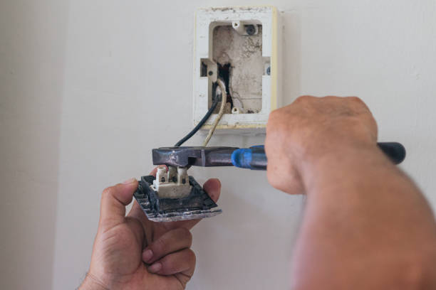 istock hands of electrician using pliers to repair a home socket 2168491846