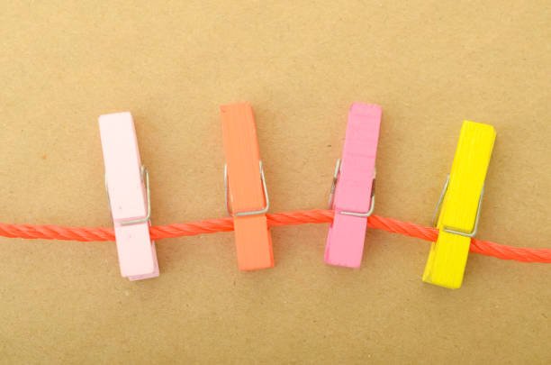 The image of clothespins on a string beautifully symbolizes the interconnectedness of different elements or ideas, illustrating the concept of unity or collaboration.