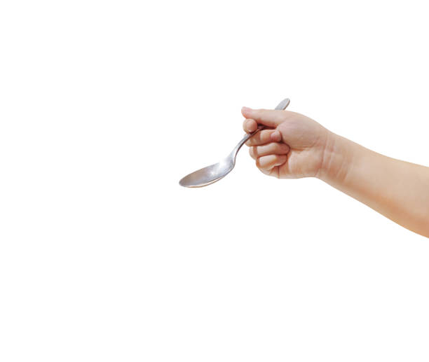 istock New shiny spoon hand holding on white background. 2168493976