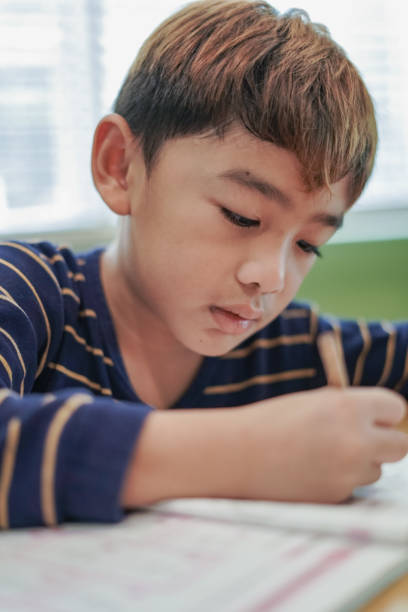 istock Children do their homework in their homework books. 2168495861