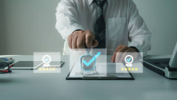 istock Standard concept. Businessman stamps document to verify service, quality assurance document. Symbol of excellent service, standards, quality assurance ISO certification 2168498384