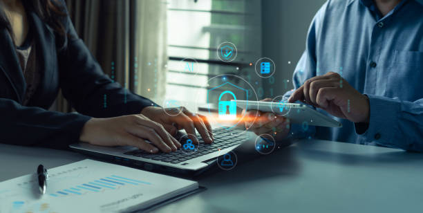 istock Cyber security and data protection.Business professionals collaborating on cybersecurity using laptop and tablet, with digital icons illustrating secure data protection private data security 2168498444
