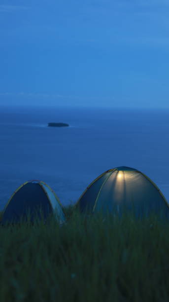 istock Camping tent on a hill with sea and sky background 2168507808
