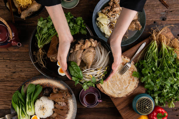 There is food on the table and holding a bowl in a pot.