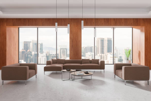 istock Spacious modern living room with brown sofas and a cityscape view through large windows, wooden walls, contemporary interior design. 3D rendering. 2168510971