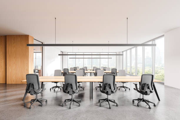 istock Office coworking interior with armchairs and desks in row, panoramic window 2168511010