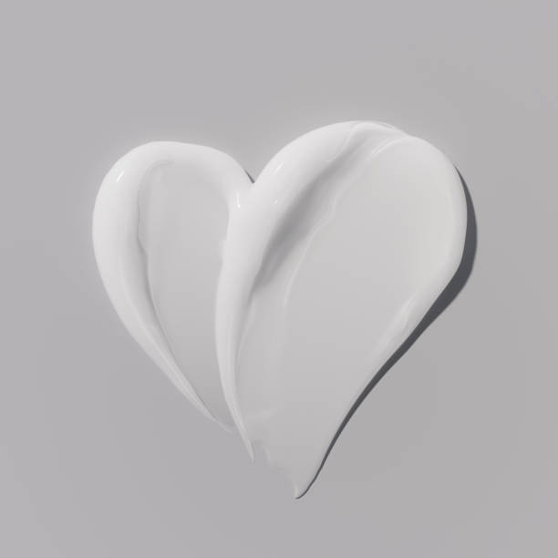 istock White cream texture in the shape of heart, moisturizer smudged on surface, 2168512847
