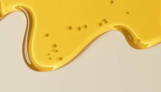 Honey texture abstract background. Yellow cosmetic gel streaks.
