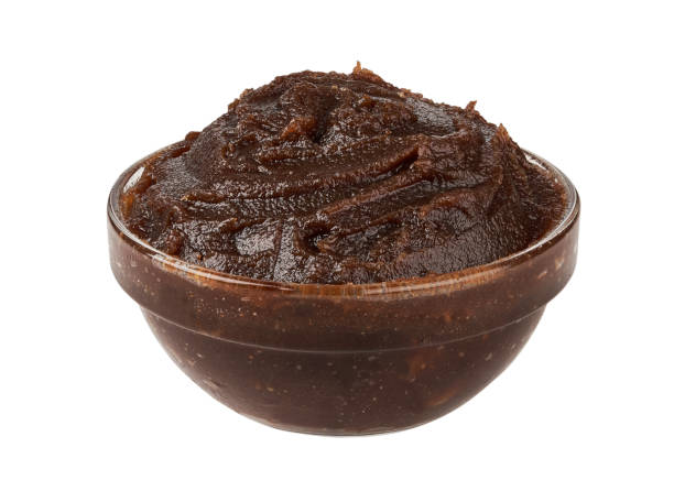 closeup date palm spread jam isolated on white background in glass bowl