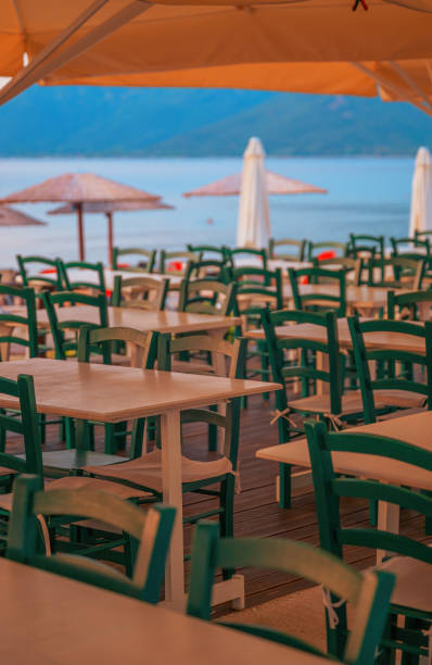 istock Empty restaurant seats and tables at seaside in the evening 2168513952