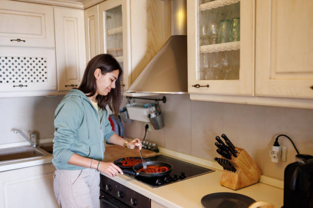 istock Young woman preparing meal at home 2168514599