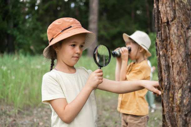 Little boy and girl are exploring the forest
