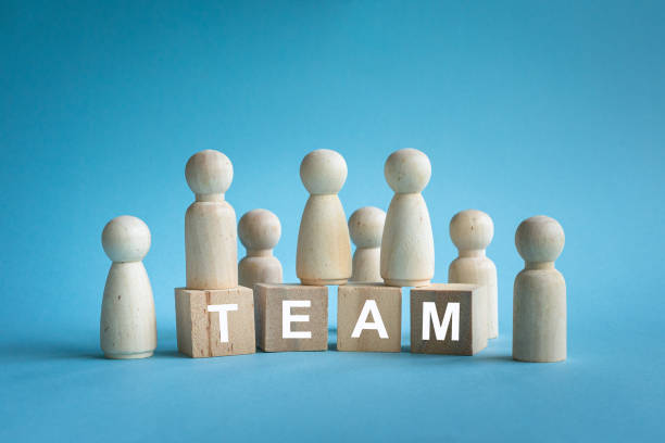 istock Team, word on wood blocks with people figures. 2168515779