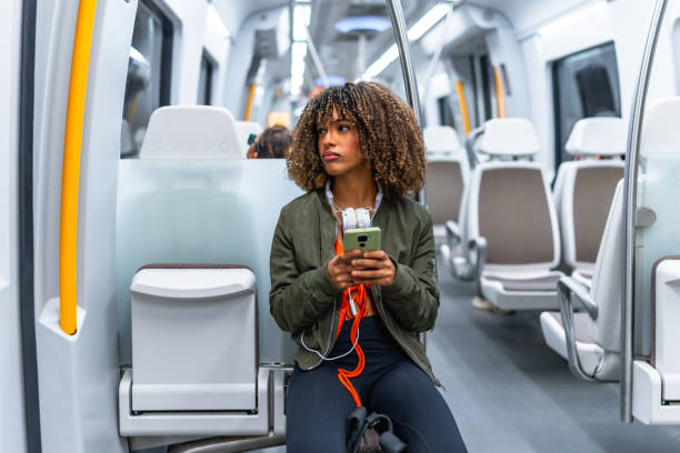 istock Latin woman sitting distracted on the metro using phone 2168516324