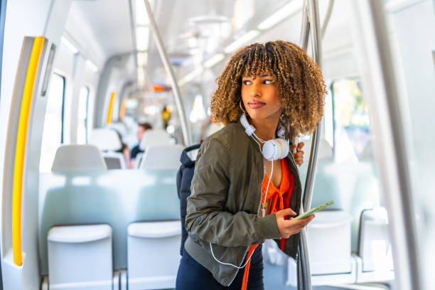 istock Latin woman using phone while looking distracted on the train 2168516338