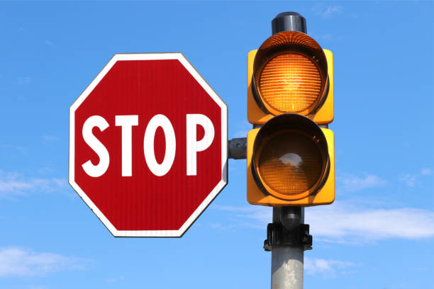 istock Stop sign and a flashing yellow traffic light 2168516971