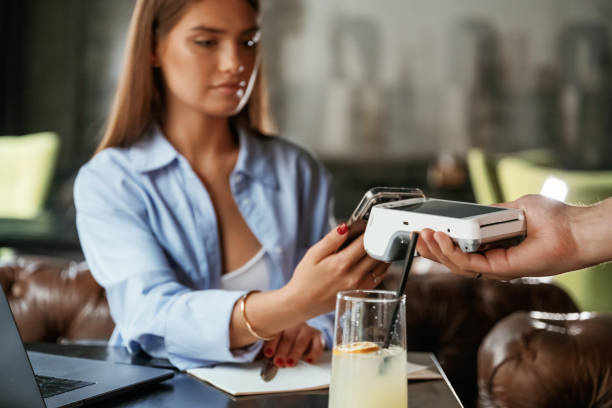 istock Using smartphone. Woman is paying for the service in the restaurant 2168518123