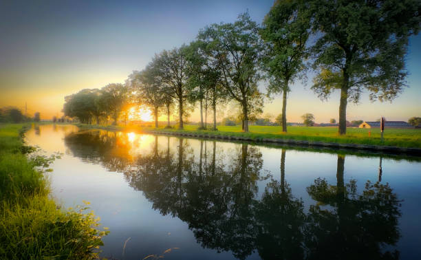 istock The Serene and Beautiful Sunset Reflections Shine on a Peaceful and Tranquil River Scene 2168518139