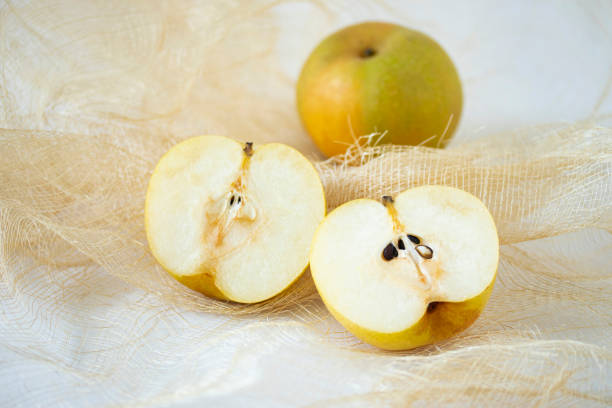 sliced juicy crisp fresh green apple from above, against oak