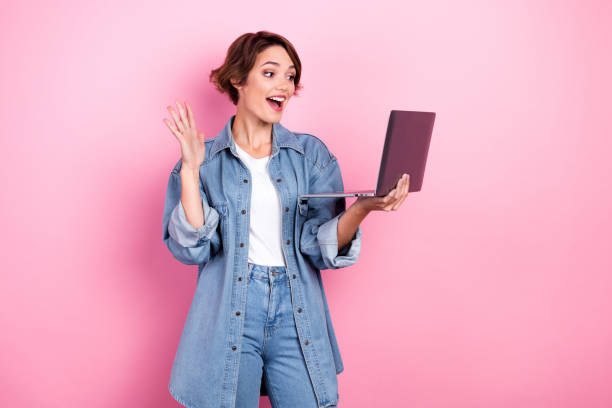 istock Photo of charming excited lady dressed denim jacket communicating modern device empty space isolated pink color background 2168525280