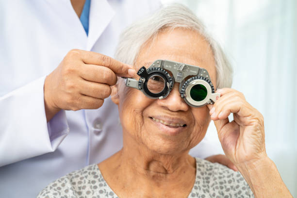 istock Asian senior woman wearing ophthalmic vision eye test and using optical trial frame. 2168526032