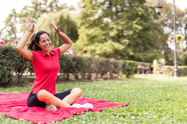istock Woman dancing happily while sitting on red mat 2168529243