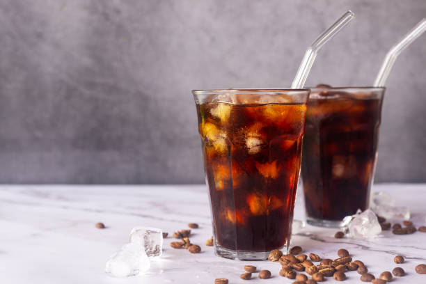 istock iced homemade cold brew coffee  with glass straw on white marble  table. 2168532332